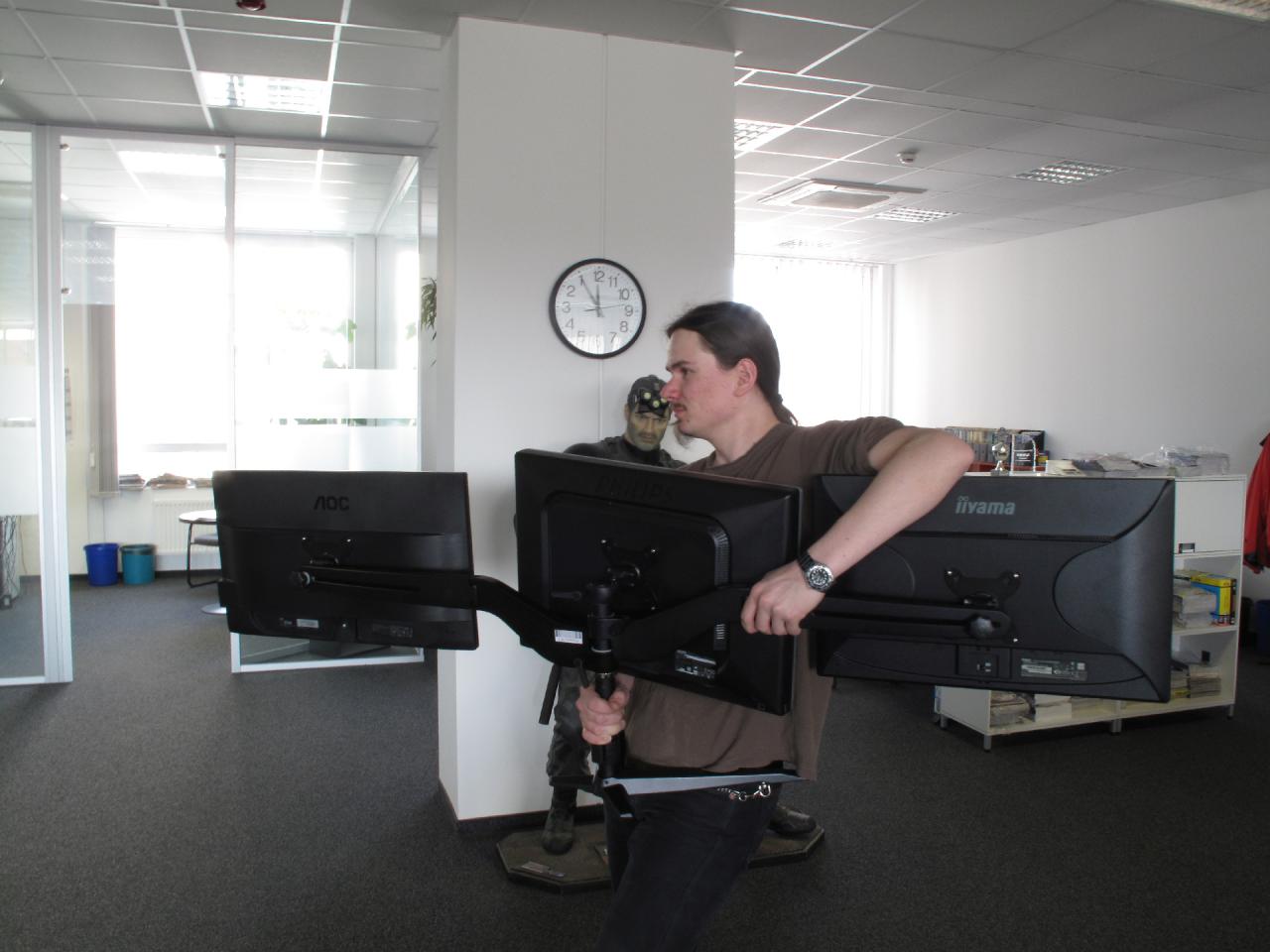 [02/04/2015] Wie dieses Bild zeigt, ist Hardware-Redakteur ein Knochenjob. Sie beobachten gerade Torsten, wie er sich auf dem Weg zum Fotolabor macht. Da er die Monitore an einem Stand befestigt hat, entfällt auch die Option, die drei Geräte getrennt zu transportieren. Weniger edle Menschen würden hier einen Praktikanten beauftragen.