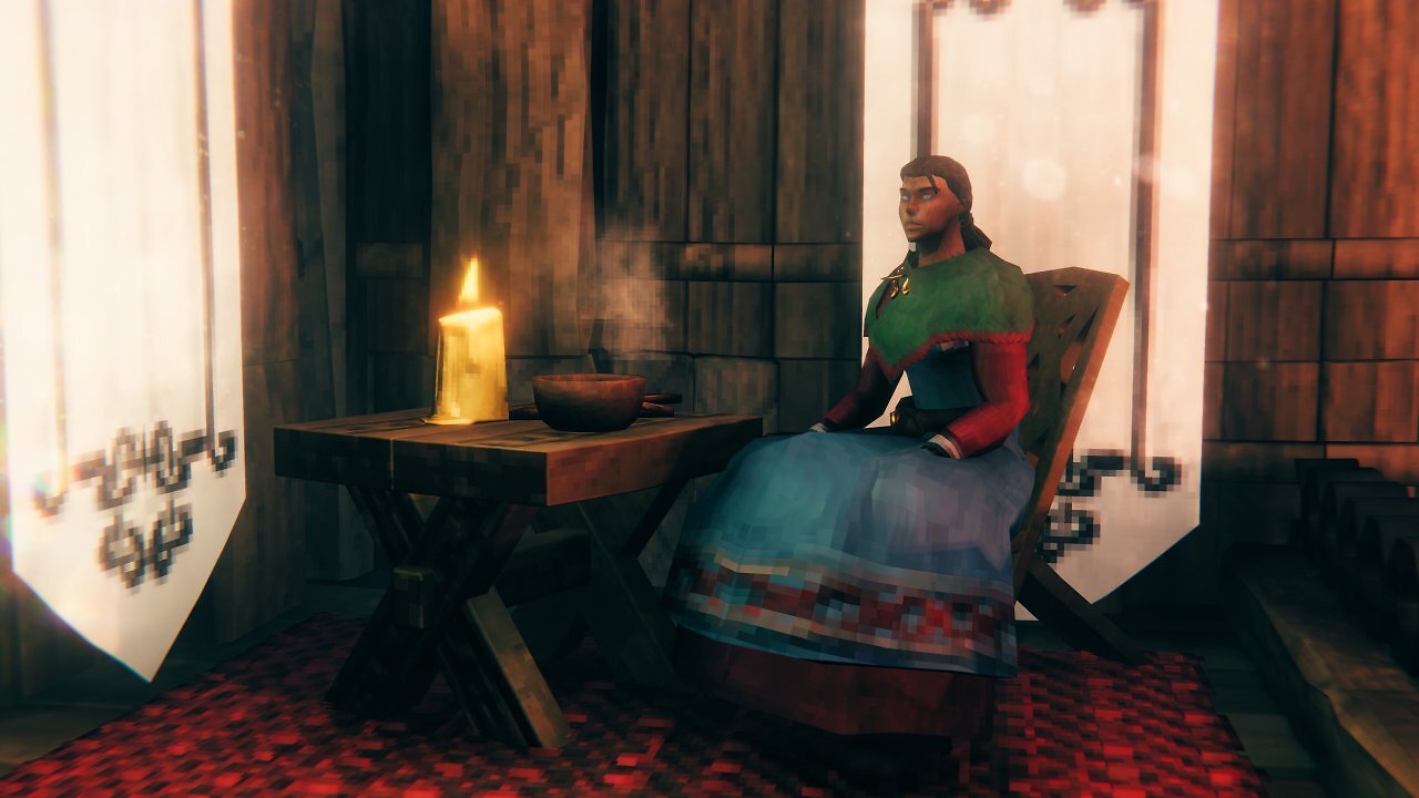 Frau sitzt auf neuem Möbel inklusive Tisch in Valheim