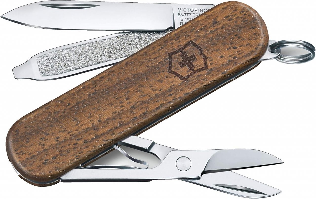 Das Classic SD Color Wood ist ein Schweizer Taschenmesser mit Nussbaumholzschalen und Funktionen wie Klinge und Schere. Es eignet sich für den Schlüsselbund.