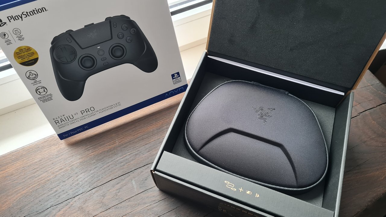 Ein schwarzer Controller mit Zubehör auf einem Holztisch.