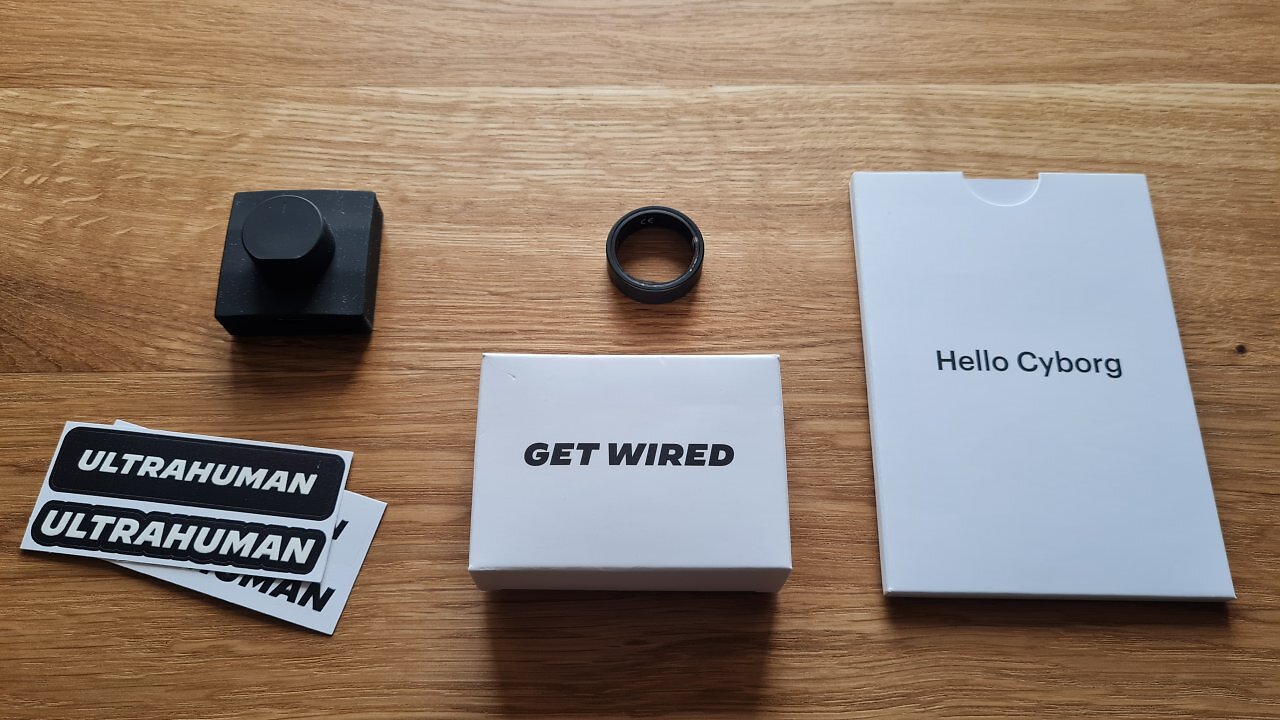 Ein Smart Ring mit Zubehör liegt auf einem Holztisch