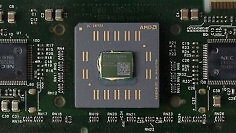 Einmal CPU-Kern, zweimal L2-Cache, eine Platine unten drunter: Der Ur-Athlon im Slot-A-Format. Ähnlich wie bei konkurrierenden Intel-Designs begrenzen die zugekauften SRAM-Chips für den Cache den Maximaltakt. Schnellere Modelle senken das Verhältnis von 1:2 auf 1:3. Ein Athlon 600 arbeitete mit 300 MHz Cache-Takt, ein Athlon 1000 mit 333 MHz.