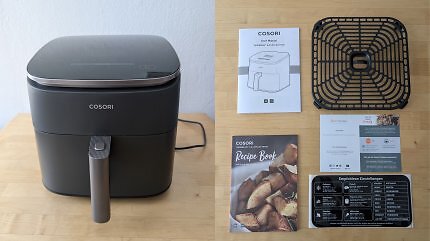 Eine Heißluftfritteuse und der zugehörige Lieferumfang.