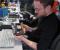 Daniel hält ein kleines Mainboard von Zotac in den Händen: Das A75-ITX Wifi im Mini-ITX-Format eignet sich für AMDs neuen Llano-Prozessor.
