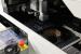 "Nun werden die vorbereiteten PCBs nacheinander in die Pick-and-Place Maschine eingeführt. Diese Bestückt die Platinen mit einer Geschwindigkeit von bis zu 10 Bauteilen pro Sekunde je nach Größe und Umfang. Jeder Arm platziert dabei bis zu 20 verschiedene Elemente auf der Platine. Die Bauelemente werden dabei &micro;m genau Platziert - bei dieser Geschwindigkeit absolut beeindruckend!"