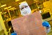 An Intel engineer holds a test glass core substrate panel at Intel's Assembly and Test Technology Development factories in Chandler, Arizona, in July 2023. Intel’s advanced packaging technologies come to life at the company's Assembly and Test Technology Development factories.